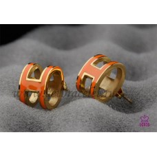 Hermes Pop H oranje oorbellen in geel goud