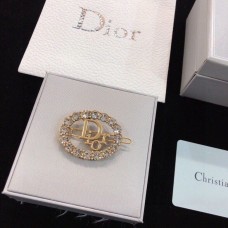 Christian Dior messing logomotief met witte kristallen en ovale broche